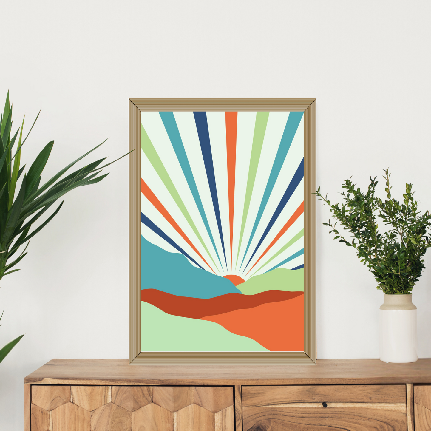 Single earthy toned sunset wall art on a wooden shelf styled with plant decor.