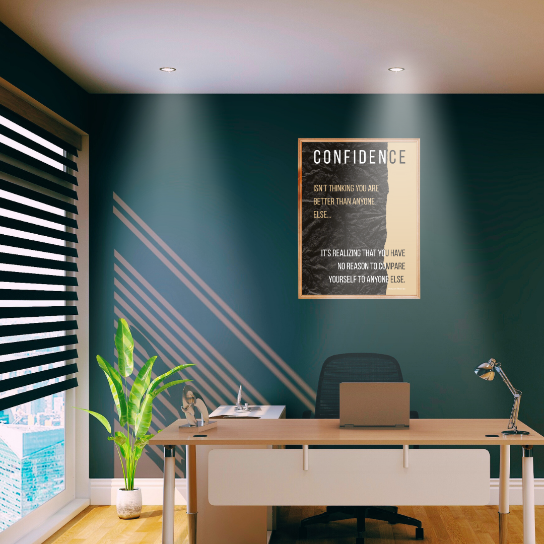 Modern office setting with motivational quote print behind an office desk with sun rays filtering through the windows.