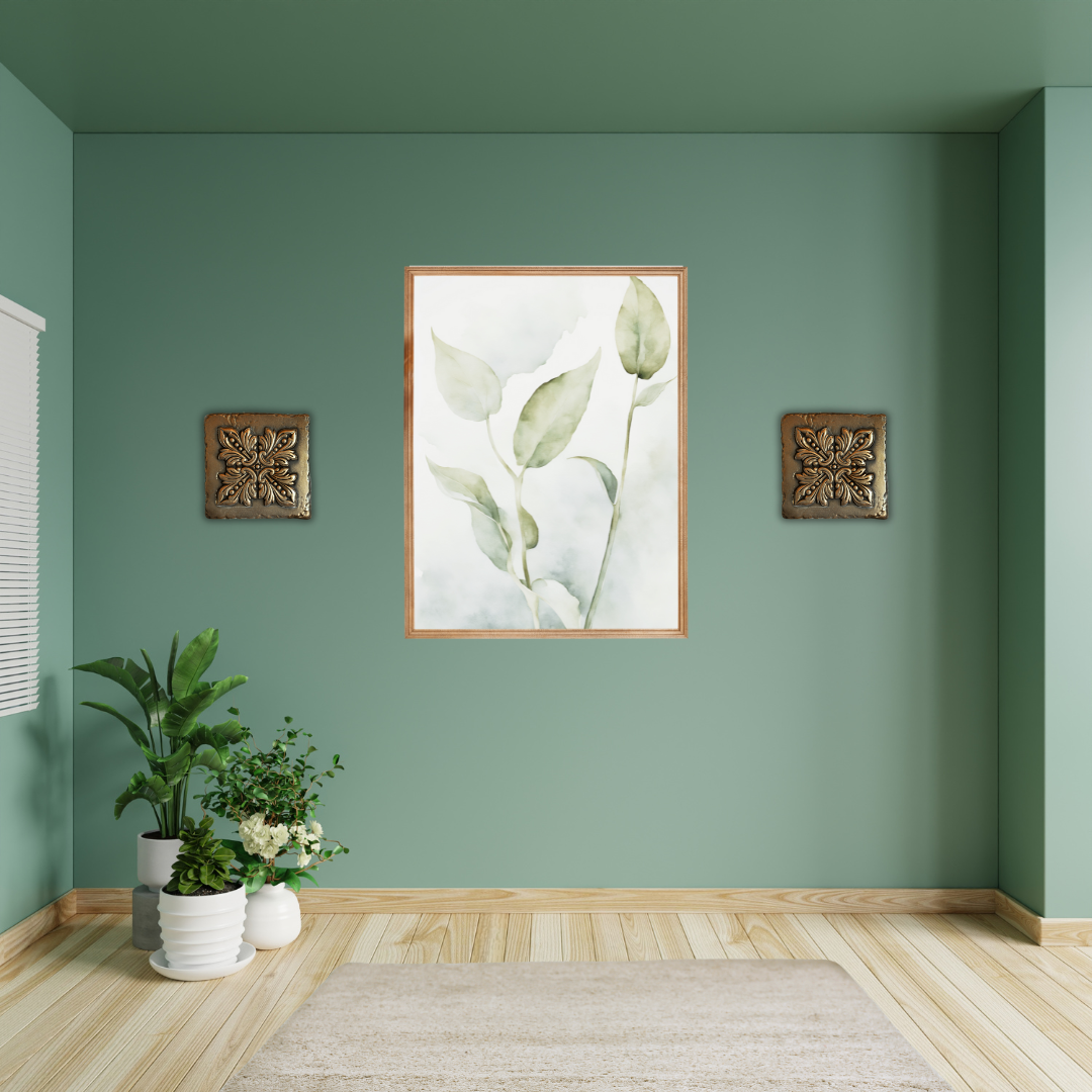 Wall art of a botanical leaf stem in soft sage and olive tones styled with gold décor.