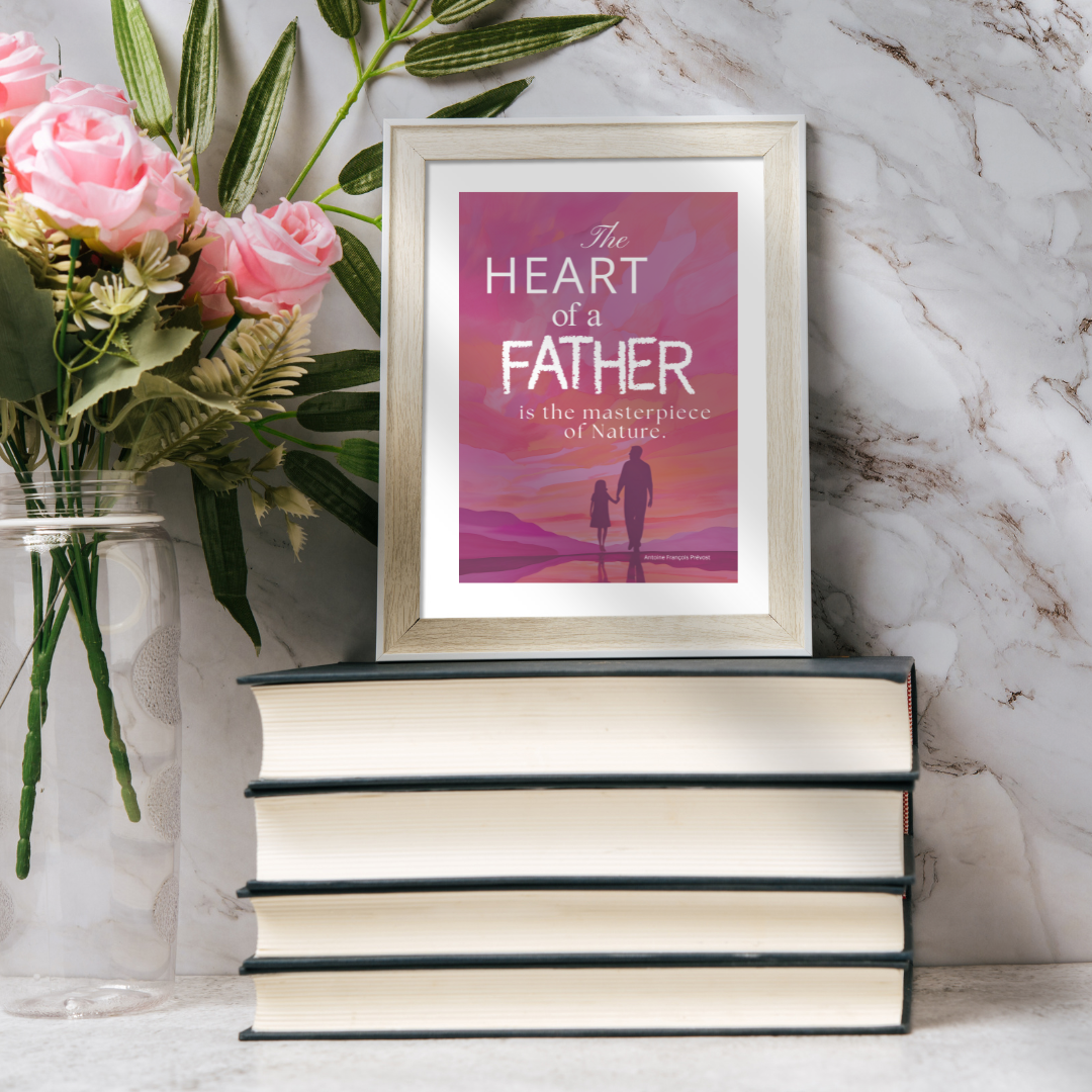 Framed “The Heart of a Father” print sitting on a stack of books on a marble shelf with roses in a glass vase.
