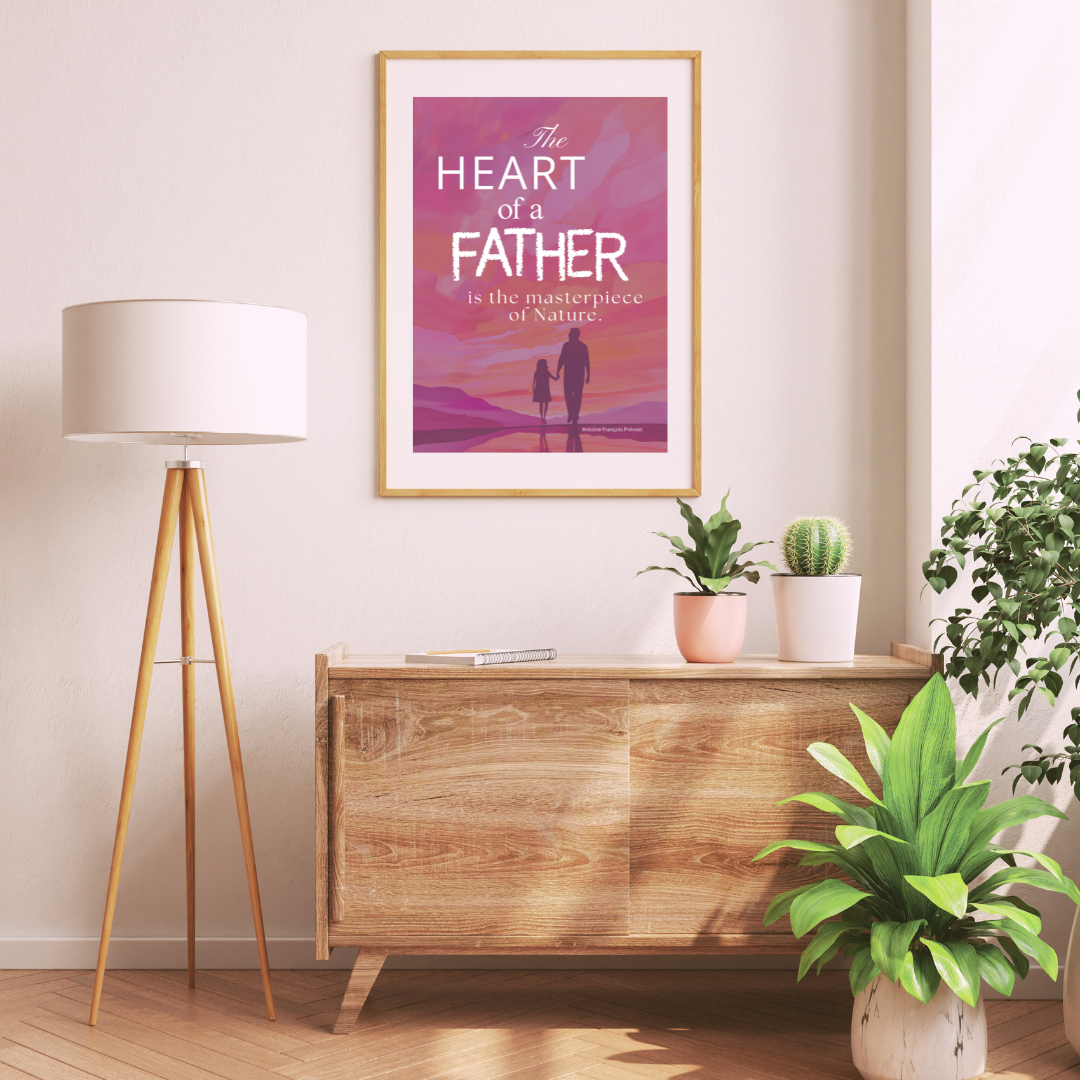 Framed “The Heart of a Father” print sitting above a wooden console table with leafy greens and earthy textures.