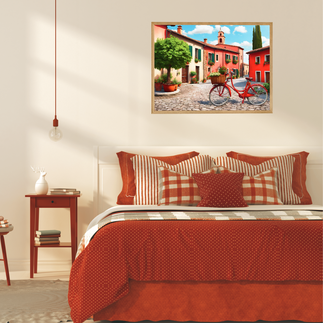 Sunlit Italian village print above a red and cream linen bed in a cozy bedroom.