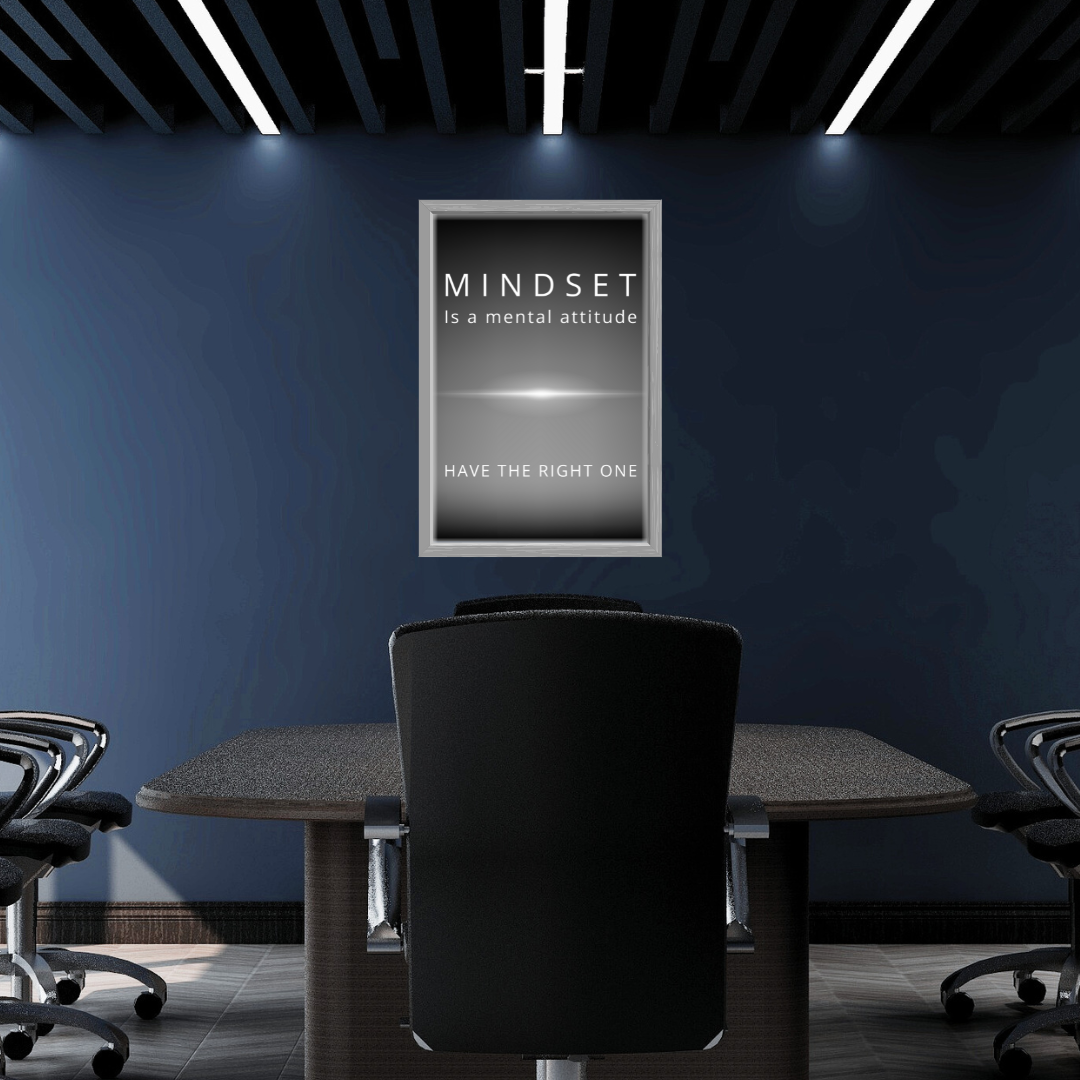 Minimalist mindset affirmation displayed on a dark-toned boardroom wall.