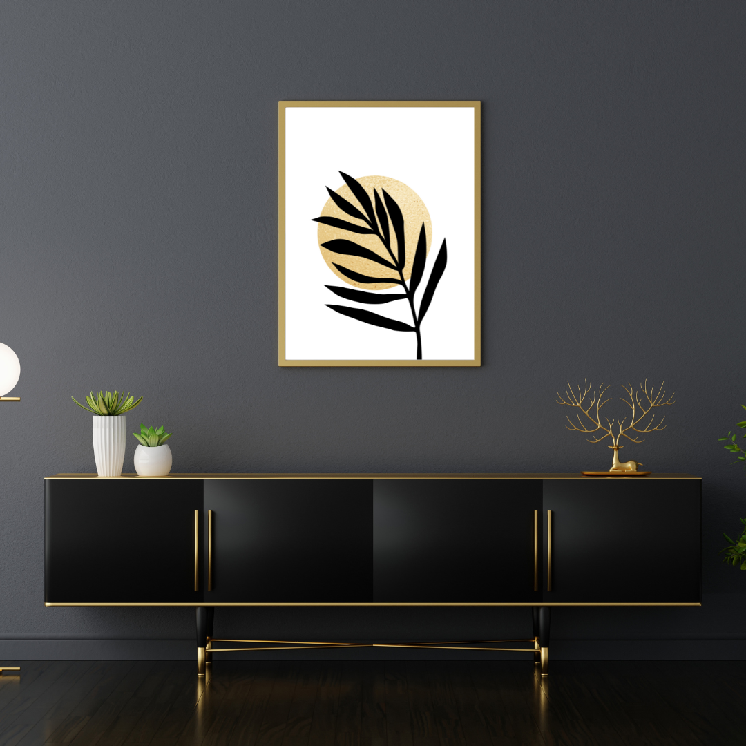 Modern interior with a black console table, decorative plants, and a framed leaf art piece in black and gold on a dark wall.