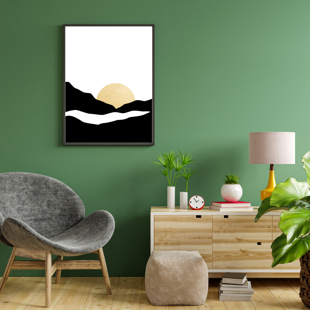 Modern reading nook with a gray chair, wooden cabinet, and a boho style black and gold abstract art piece mounted on a green wall.