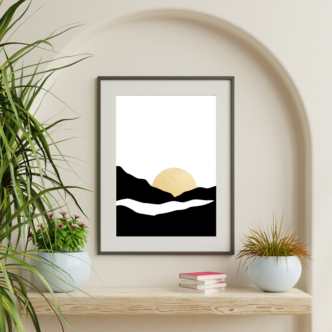 Framed artwork of a mountain landscape with a sunset mounted on a neutral arch wall above a wooden shelf with potted plants.