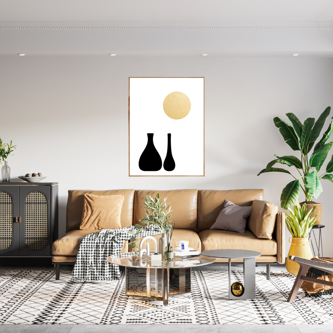 Modern living room with a tan sofa, coffee table, and decorative elements with boho style black and gold wall art of black boho vases and a gold sun.