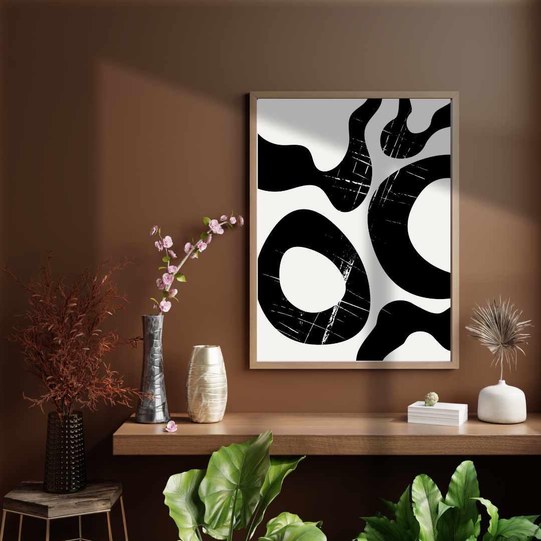 Japandi black and cream artwork on a wall above a wooden console table with decorative items.
