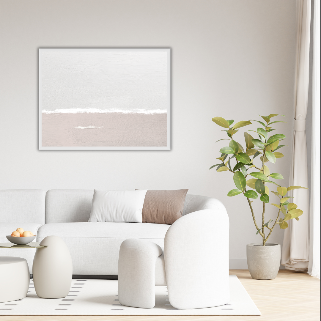 Modern living room with white sofa, ottoman, and plant against a soft wall featuring a minimalist landscape art piece.