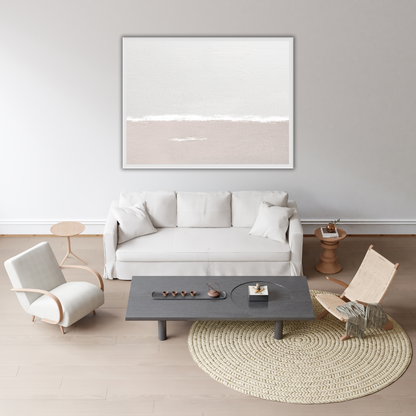 Sea and sky landscape wall art in a minimalist Japandi living room with a white sofa, coffee table, and chairs.