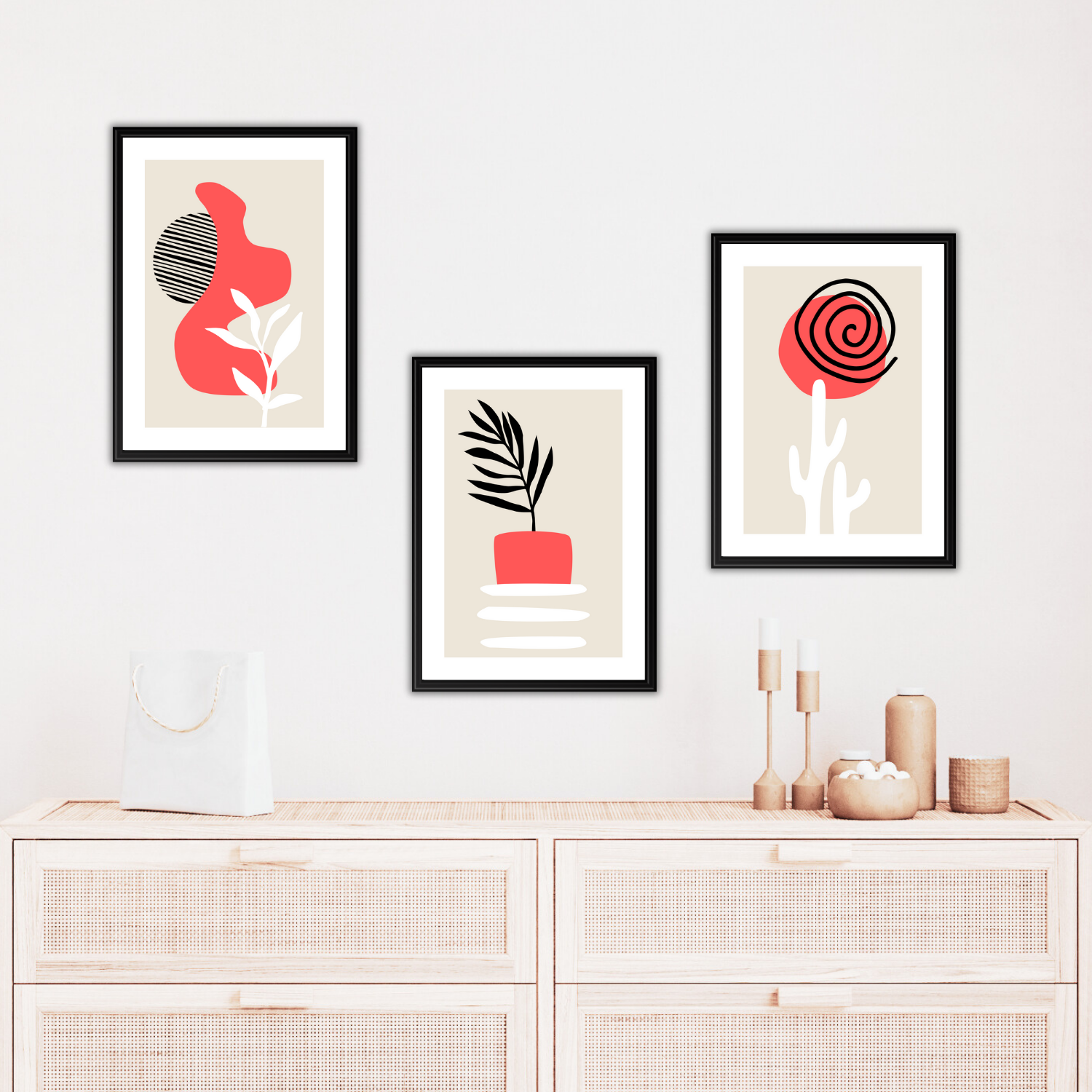 Abstract boho decor prints in coral, white and black with natural textures and shapes above a shelf.