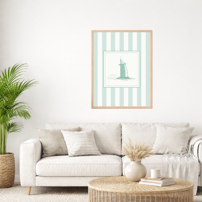 Framed striped coastal wall art of the Burj Al Arab in sea green on a wall above a sofa in a neutral living room.