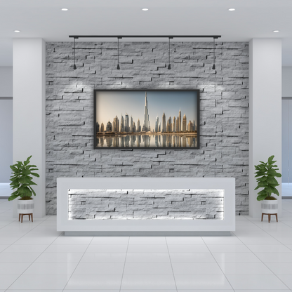 Elegant Dubai skyline print hanging above a reception area in a corporate office lobby, with modern brick decor.