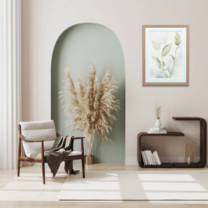 Framed botanical print with neutral tones of faded sage and smokey cream in a minimalist setting.