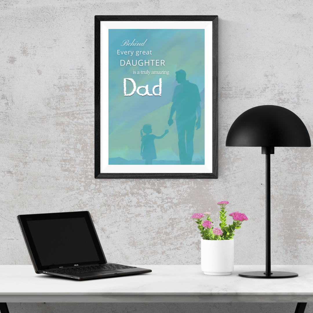 Modern home study with laptop and black lamp – Minimalist workspace featuring framed inspirational dad quote artwork.
