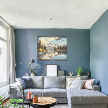 Large lake‑landscape canvas hanging over a grey sofa in a cozy living room.