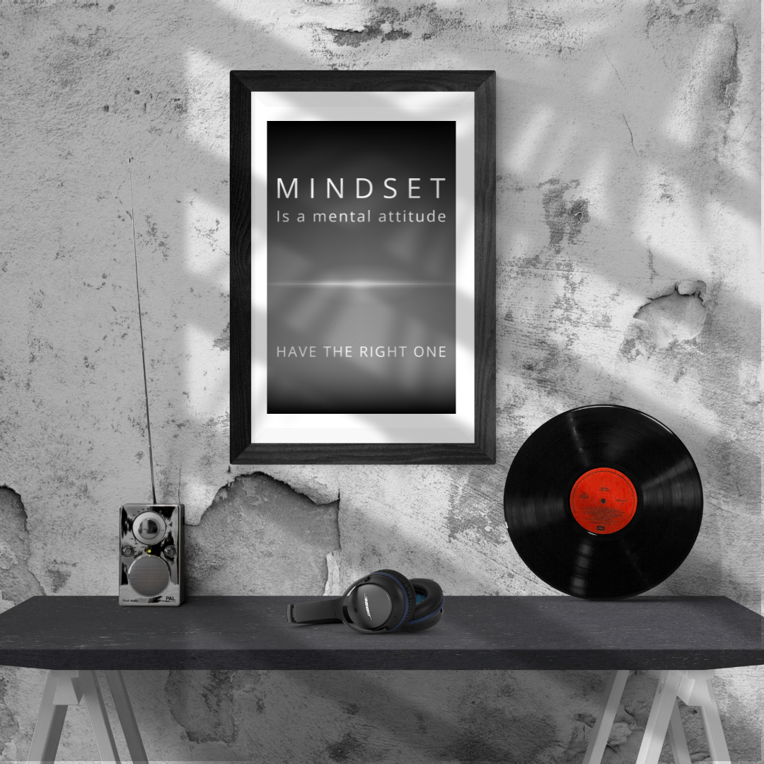 Printable mindset quote displayed on a sleek console next to music gadgets.