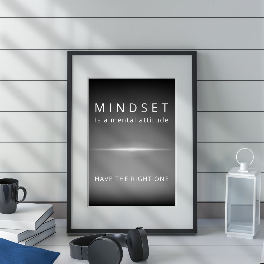 Mindset wall art on a shelf in a modern workspace with neutral tones.