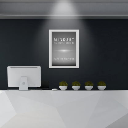 Framed motivational print in an office reception area with modern decor.
