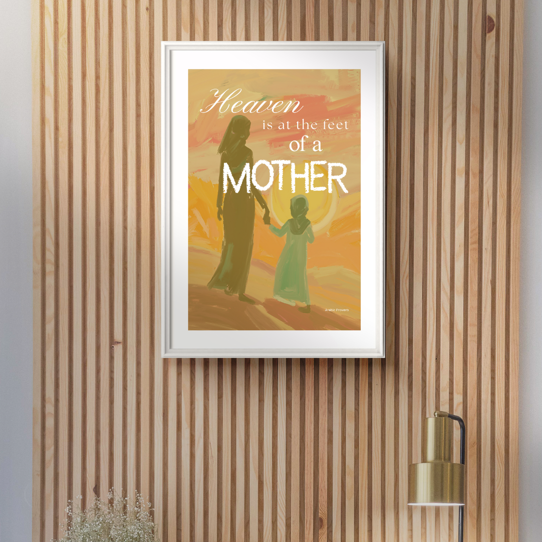 Framed poster with a mother and child silhouette and 'Heaven is at the feet of a mother' text on a wooden wall.