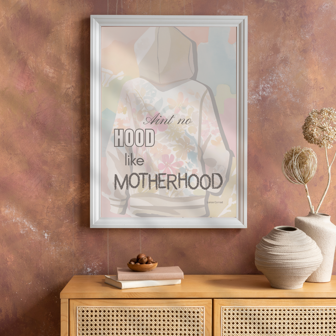 Framed “Ain’t No Hood Like Motherhood” print above display console with rustic decor.