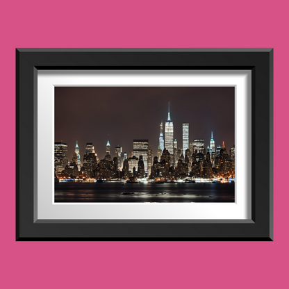 Close-up of New York skyline wall art in matte black frame showing lit windows and reflections.