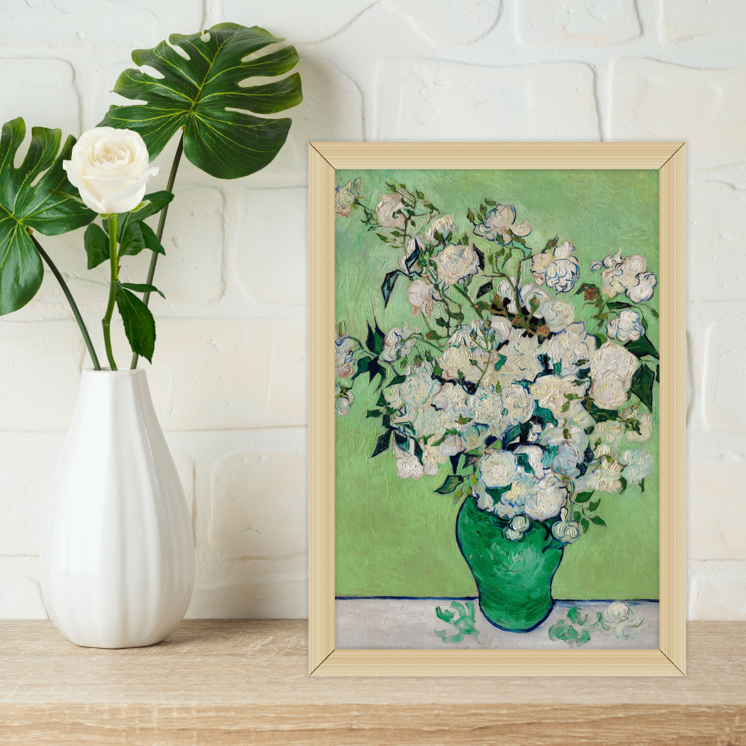 Close‑up of Van Gogh Roses print in natural wood frame on a wooden shelf with a potted plant.