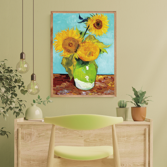 Home wooden desk with Van Gogh's Sunflowers print with potted plants decor.