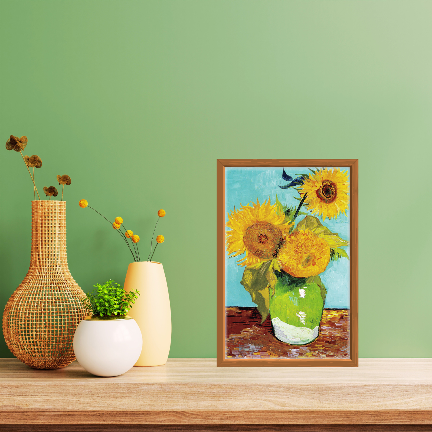 Close‑up of Sunflowers print in a natural wooden frame on a minimalist shelf with rattan and ceramic decor.