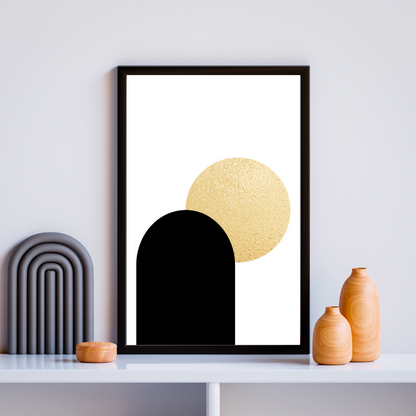 Framed boho style abstract art print with black and gold shapes on a white wall and boho decor.