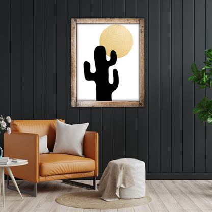Reading nook with a tan sofa, side table, pouf, and a framed cactus boho style artwork on a black wall.