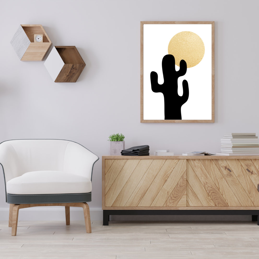 Modern neutral interior with a cactus and sun boho style artwork on the wall, white chair, and wooden cabinet.