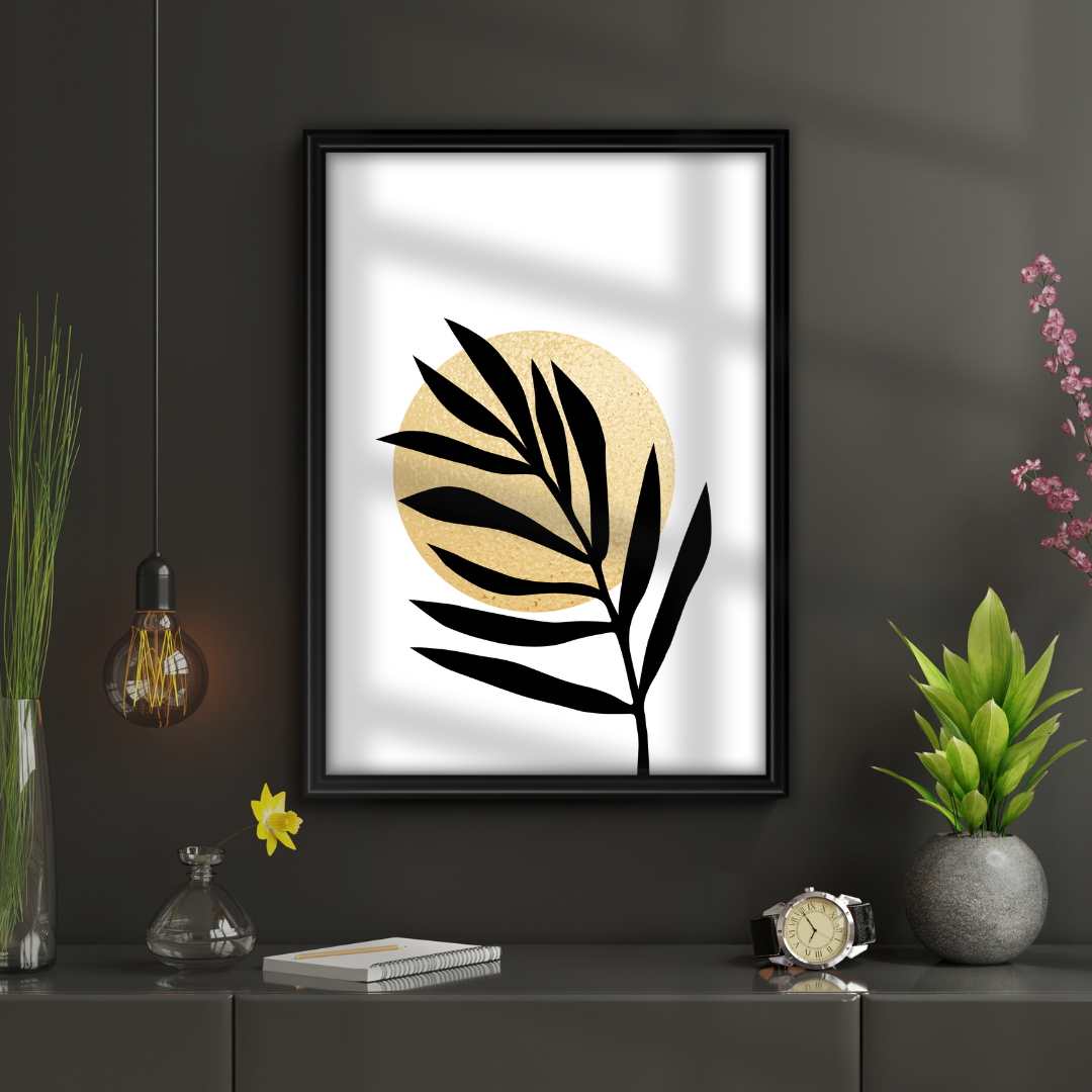 Framed artwork with black and gold leaf design on a dark wall above a shelf with decorative items.