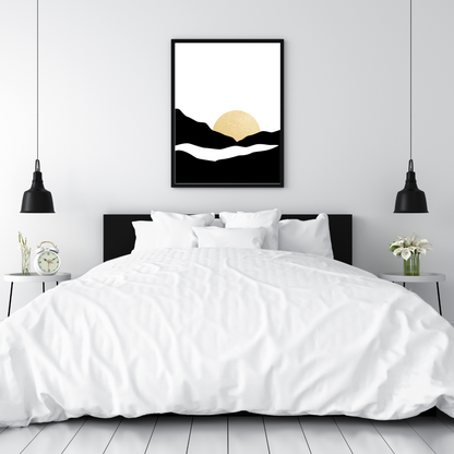Framed black and gold sunset abstract artwork above a bed with white bedding and black headboard.