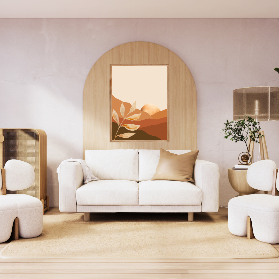 Boho wall art print featuring a mountain and a setting sun framed above a white and wood minimalist couch setting.