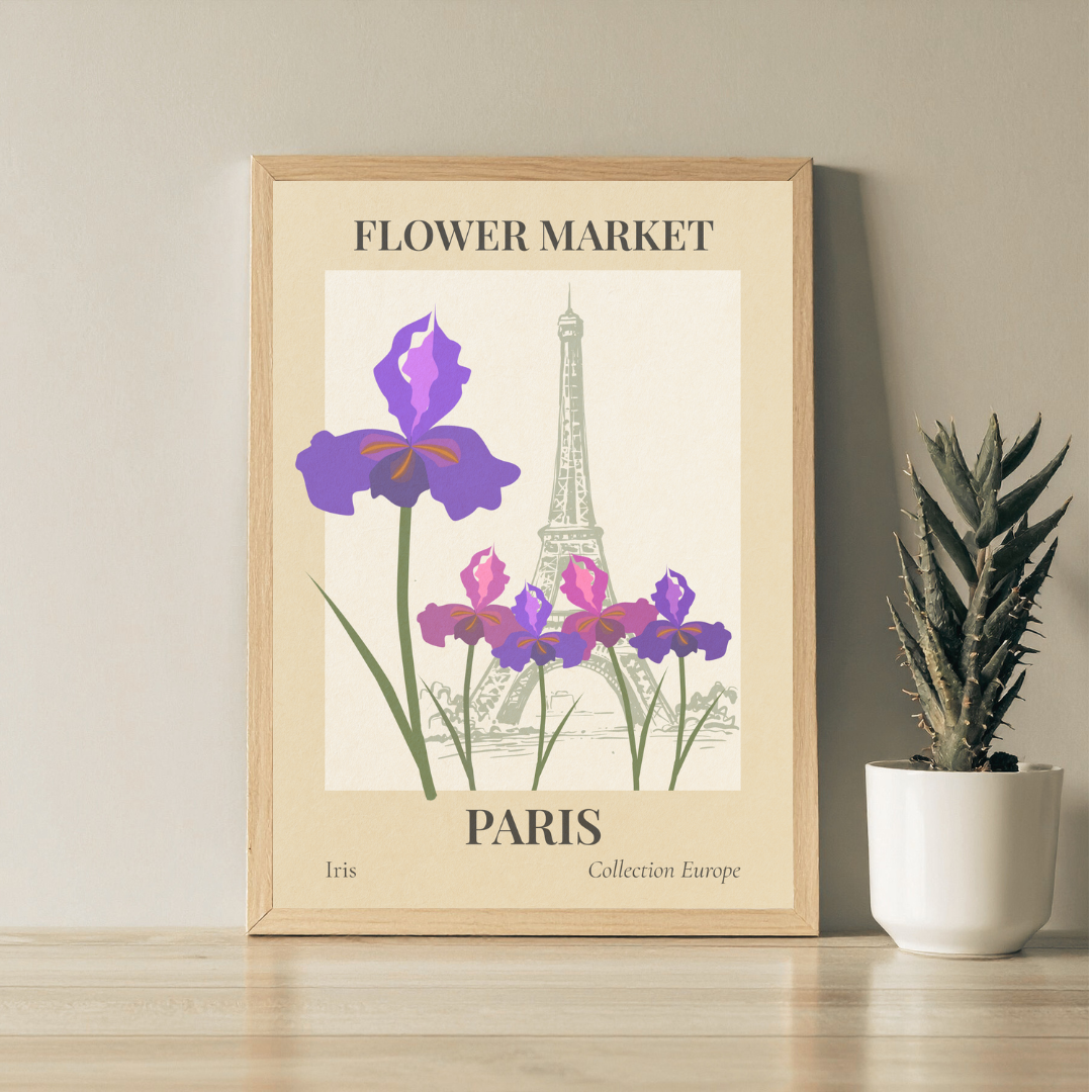 Framed flower market wall art with Eiffel Tower and iris flowers on a beige wall with a plant below.