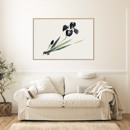 White sofa in a living room with a framed Japanese ink botanical print on the wall.