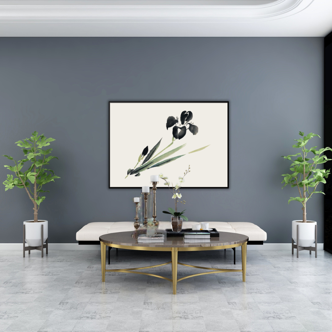 Modern Japandi style living room with a gold coffee table, plants, and a framed 19th century artwork of an iris on a gray wall.