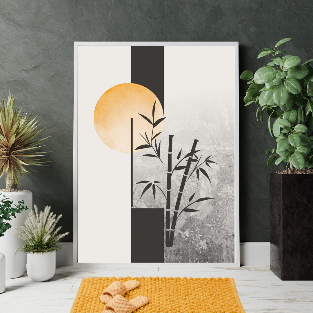 Close up of a framed Japandi artwork with a sun and bamboo design against a charcoal gray wall with plants around.