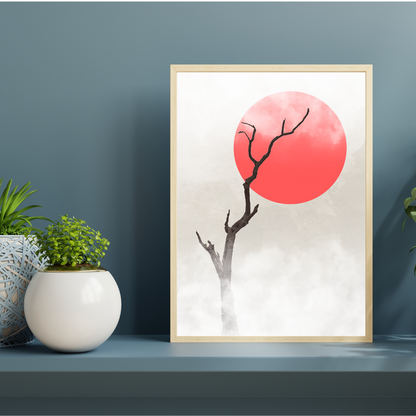 Framed Japandi artwork with a red sun and bare tree against a light background, placed on a shelf with plants.