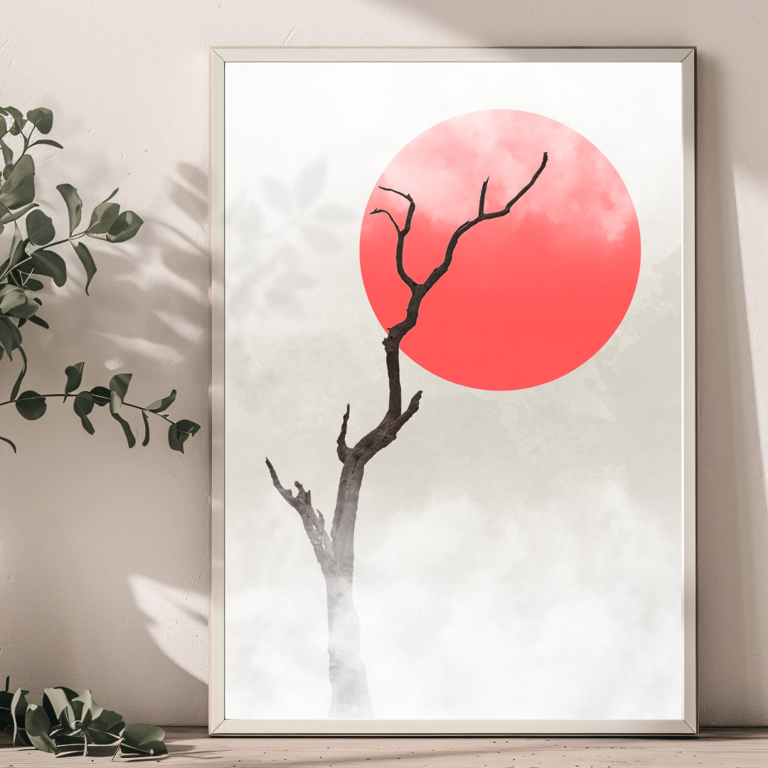 Framed artwork of a tree with a red sun leaning against a neutral textured wall.