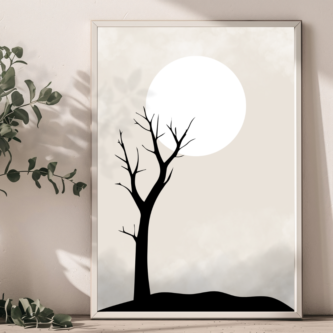 A closeup of a framed artwork of a black tree silhouette against a neutral background with a full moon.