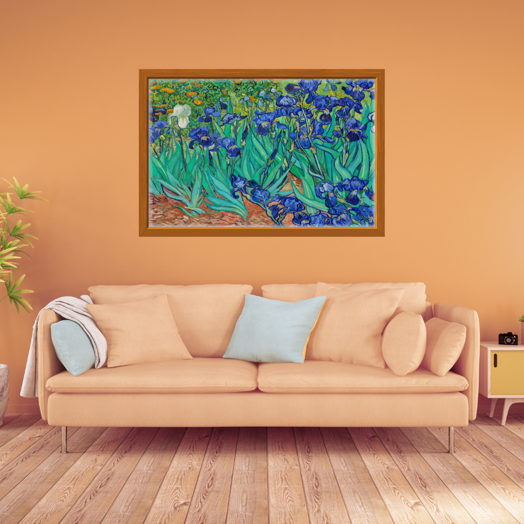 Van Gogh Irises print in vivid blues and greens framed above a sofa in an earthy orange setting.