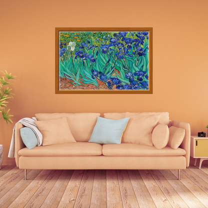 Van Gogh Irises print in vivid blues and greens framed above a sofa in an earthy orange setting.