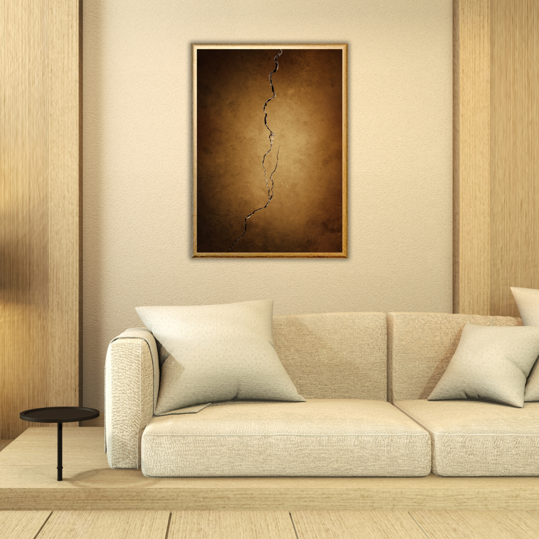 Beige sofa with decorative pillows in a room with wooden walls and a framed abstract painting.