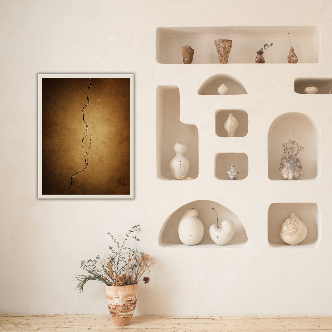 Wall with Japandi decorative shelves and a framed Kintsugi earth-toned artwork in a room.