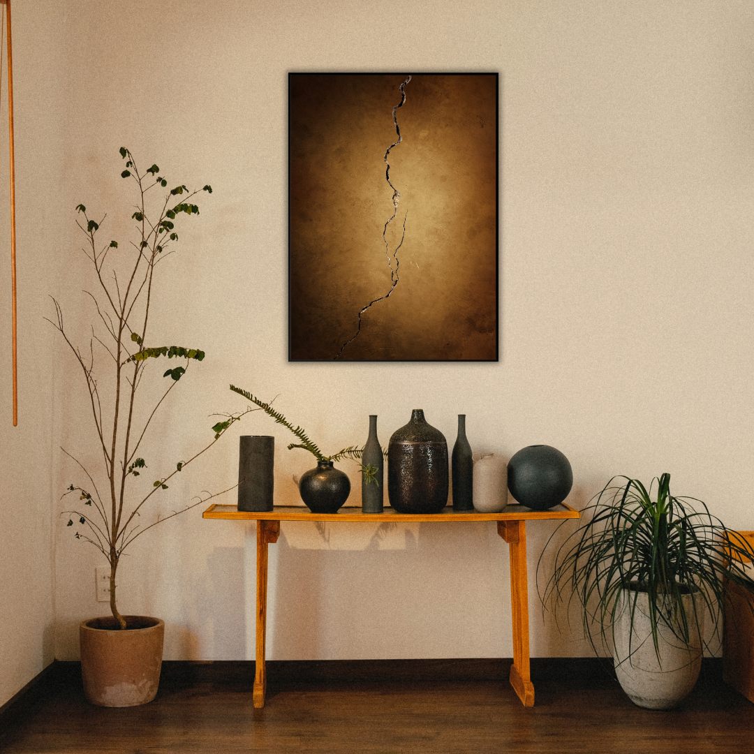 Decorative setup with a table holding Japandi vases, plants, and a Wabi Sabi wall art piece above.