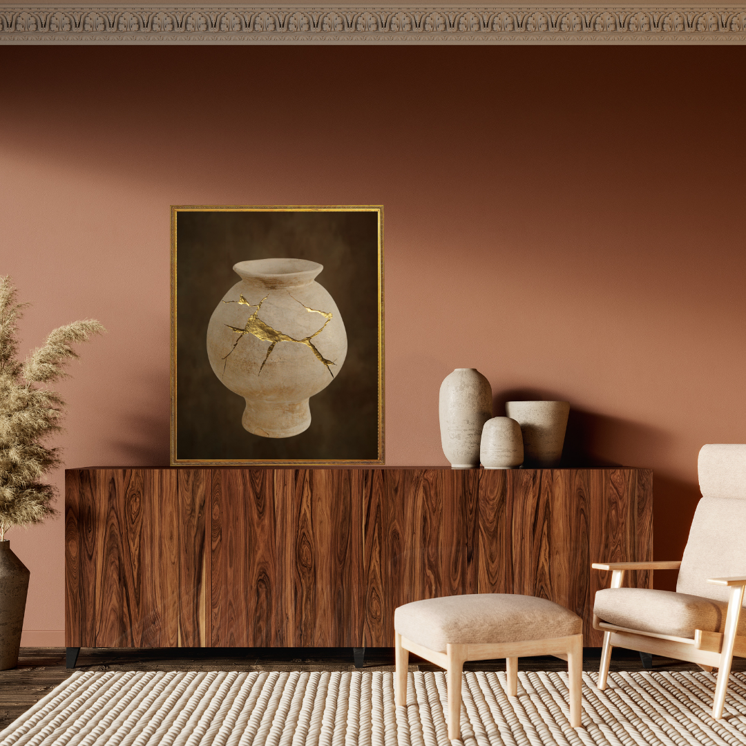 Japandi styled living room with wooden console table, decorative vases, and a framed Wabi Sabi artwork of a golden mended vase on a terracotta wall.