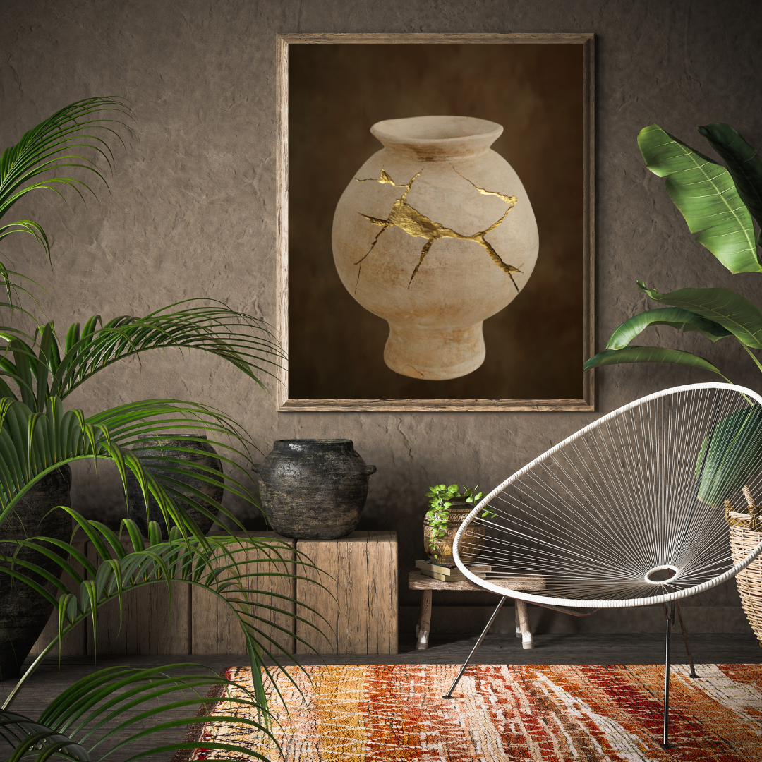 Japandi styled nook with a modern chair, plants, and a framed Wabi Sabi artwork of a cracked vase on a textured wall.