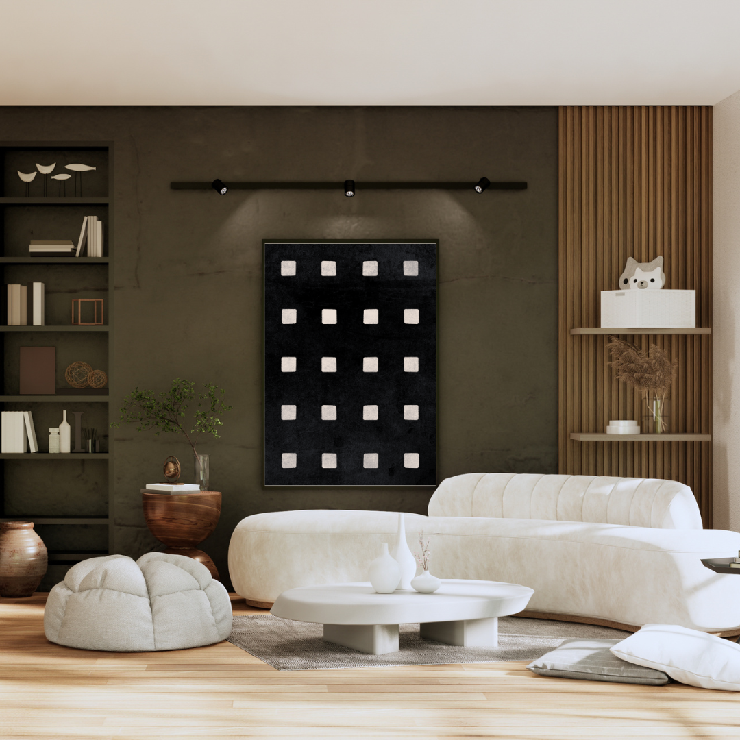 Modern living room with white sofa, coffee table, and decorative items featuring Wabi Sabi wall art of ivory squares on a soft black background framed against a rustic Wabi Sabi styled wall.